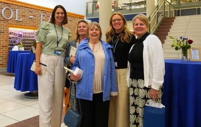  Several retirees smile together in the lobby of CB East.